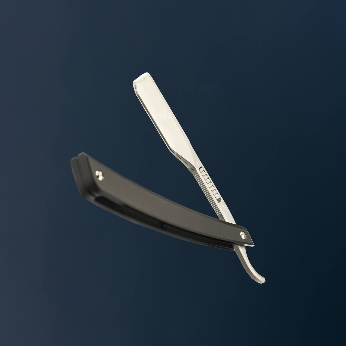 Professionel barberkniv med sort skaft og blankt barberblad på mørk blå baggrund – klassisk shavette til præcis vådbarbering og trimning af skæg.